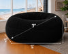 Black bean bag chair with measurements in a room with large windows showing a beach view.
