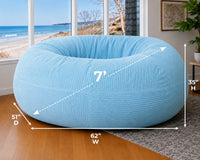 Blue bean bag chair with dimensions in a room with a beach view